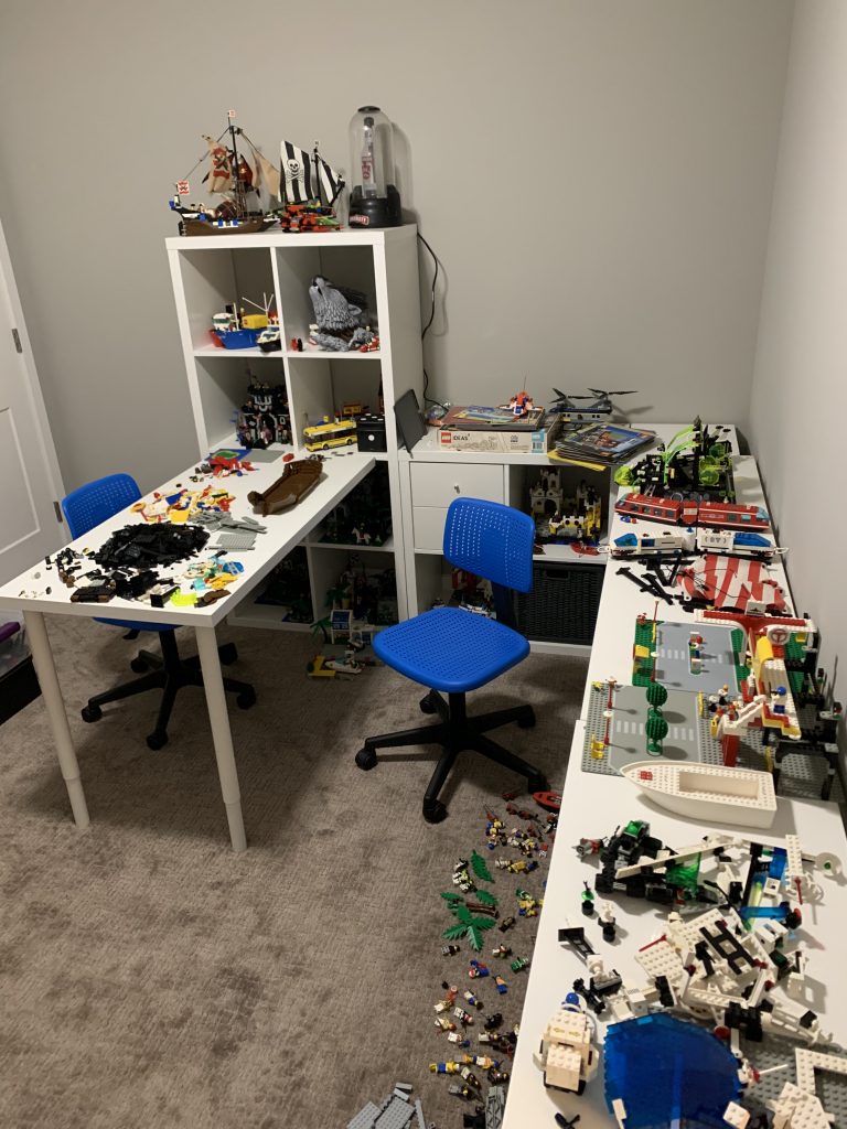 Photograph of game room coming together with built LEGO sets sitting in cabinetry.