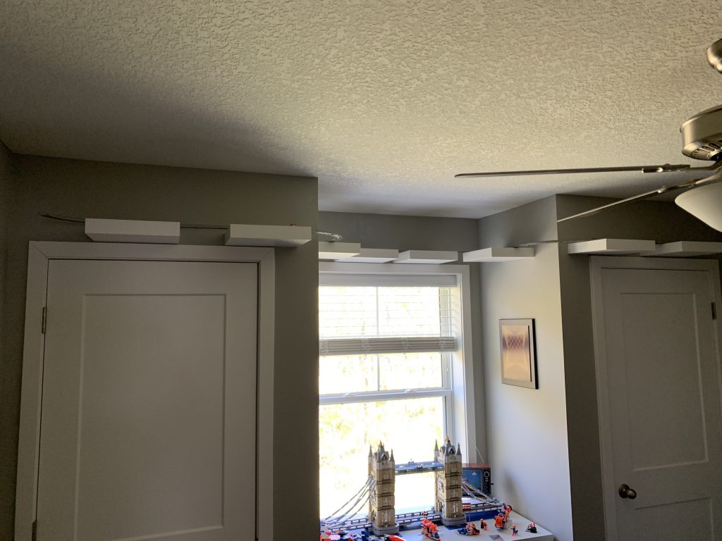 Photograph of game room where shelving is now ran long 3rd wall within room along with monorail track.