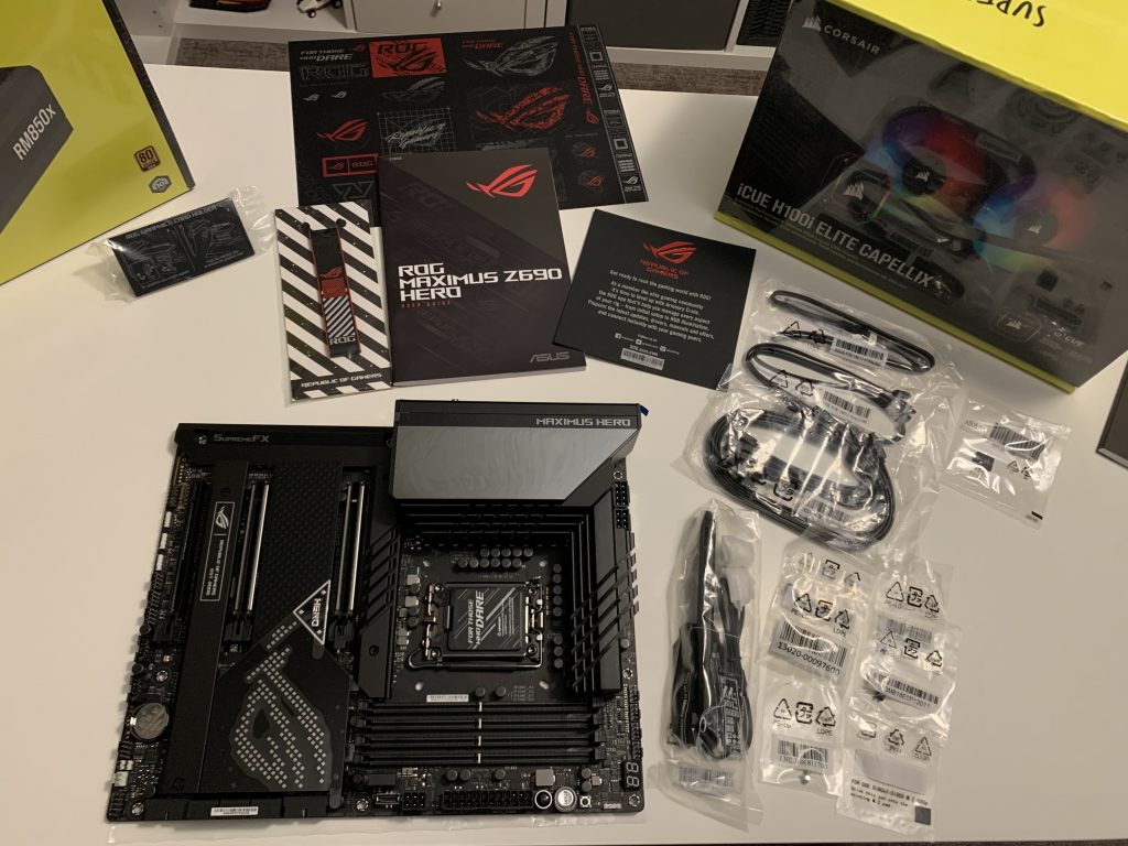 Photo of contents of motherboard box laid out along table