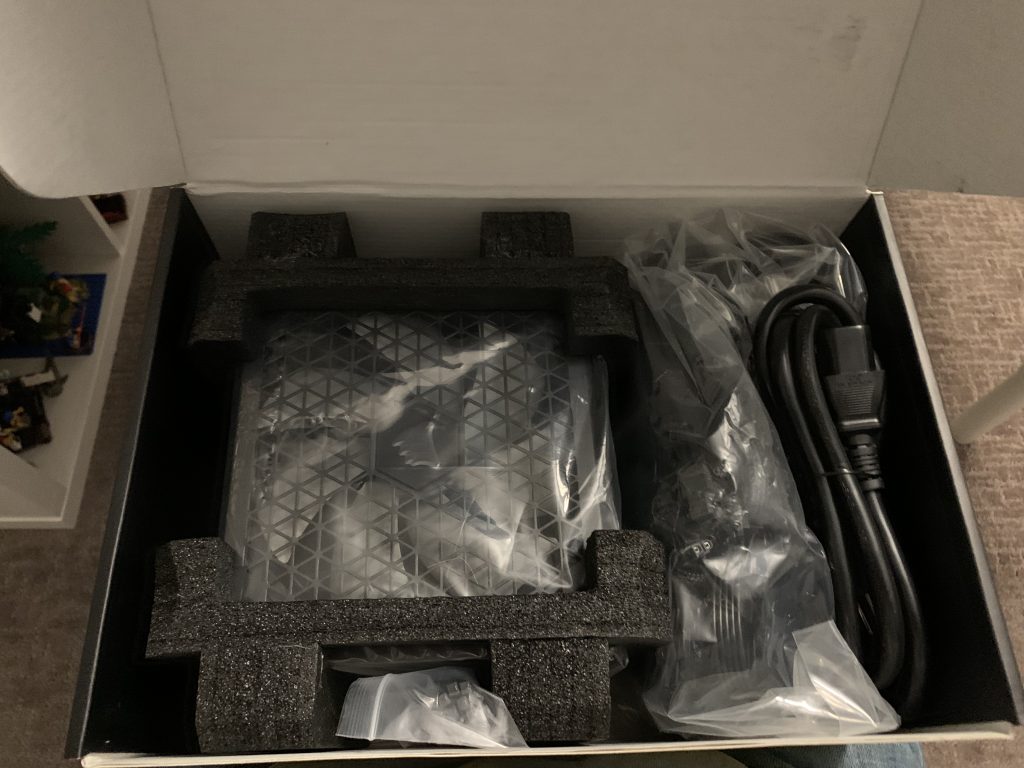 Photo of power supply sitting inside box with packaging