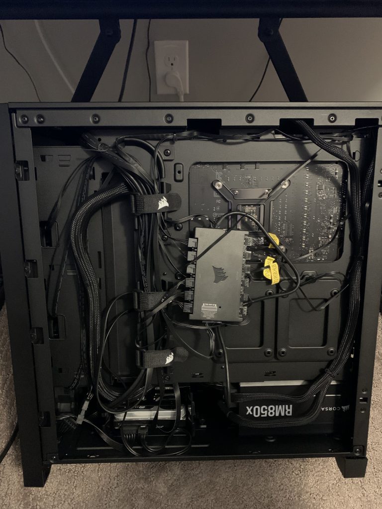 Photo showing the back side of the opened computer where all of the cable management is located