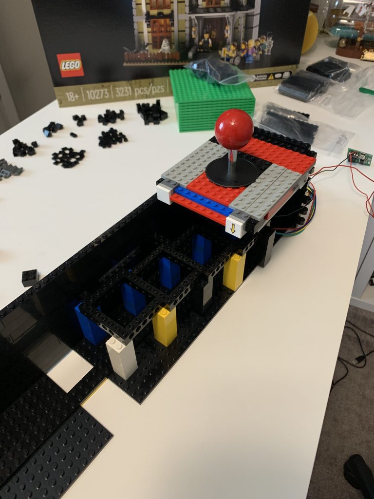 Photo showing a closer look at the joystick mounted inside the control panel to the internal supporting beams - top angle.