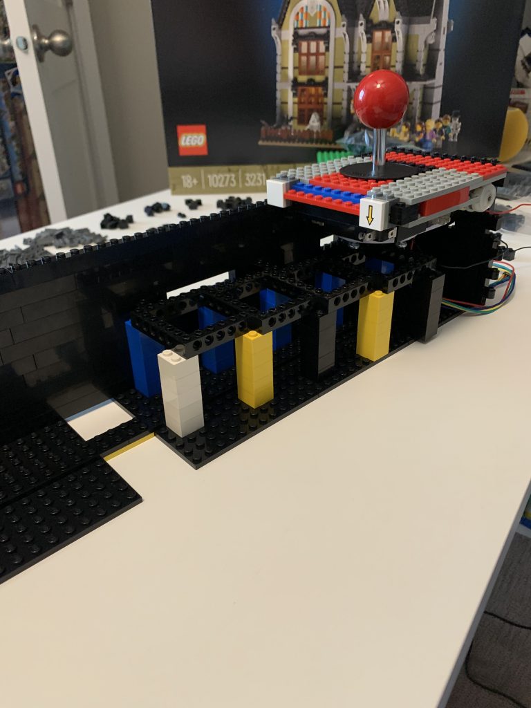 Photo showing a closer look at the joystick mounted inside the control panel to the internal supporting beams - side angle.