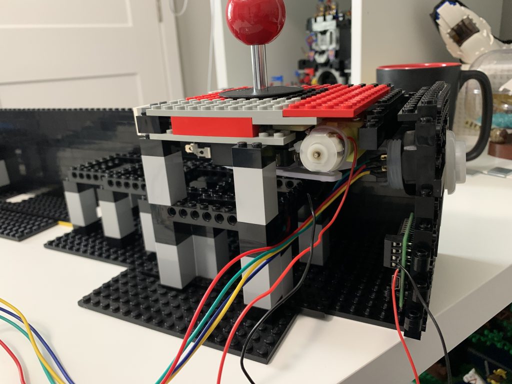 Photo showing the inside corner of the player 1 joystick and control board mounted and secured to the LEGO control panel.