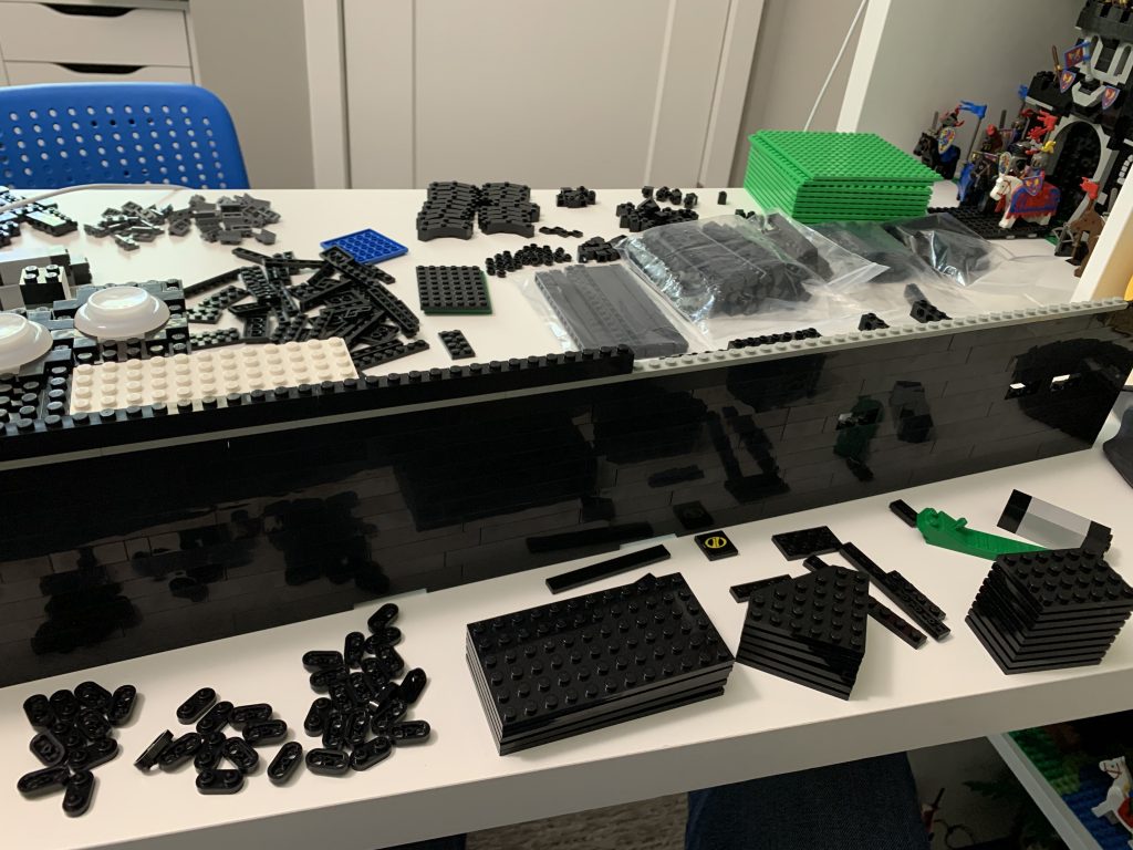 Photo showing the front of the control panel and lots of pieces laid out in front and behind of it.