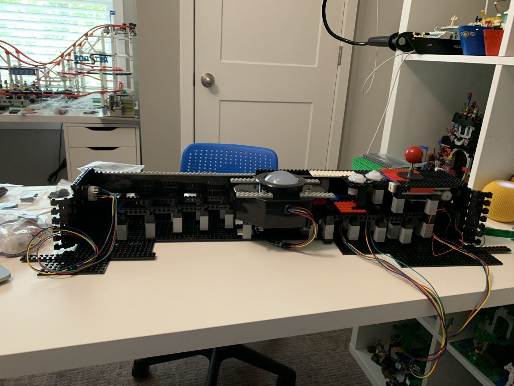 A reverse view of the control panel, showing the skeletal structure inside and the unmounted trackball sitting in place.