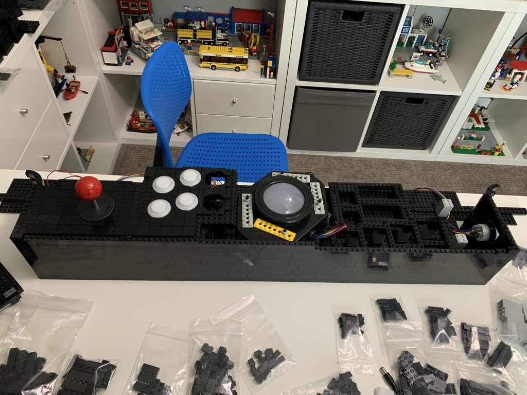 Photo showing the entire control panel, top down, with 4 of the 6 player 1 buttons installed into the control panel.