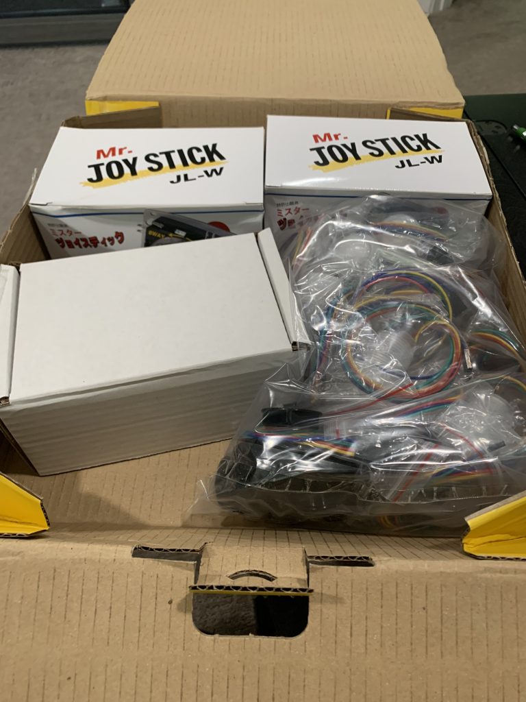 Photo of inside the DHL box showing joysticks and buttons and all sorts of goodies.