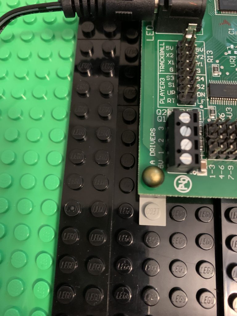 Photo showing LEGO microphone pushed through the circuit board