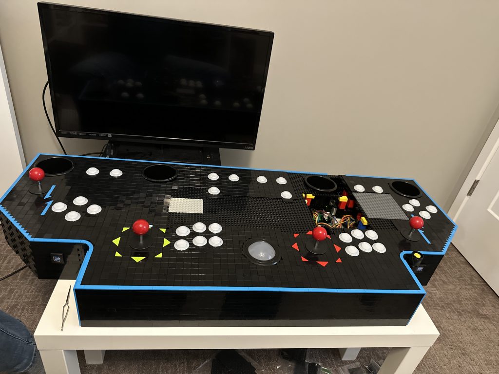 Photo of plates getting installed onto the top of the control panel, covering it up.