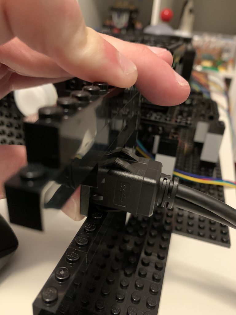 Photo showing the USB port place between bricks, but the prongs don't latch on because they are too large, these need to get clipped.