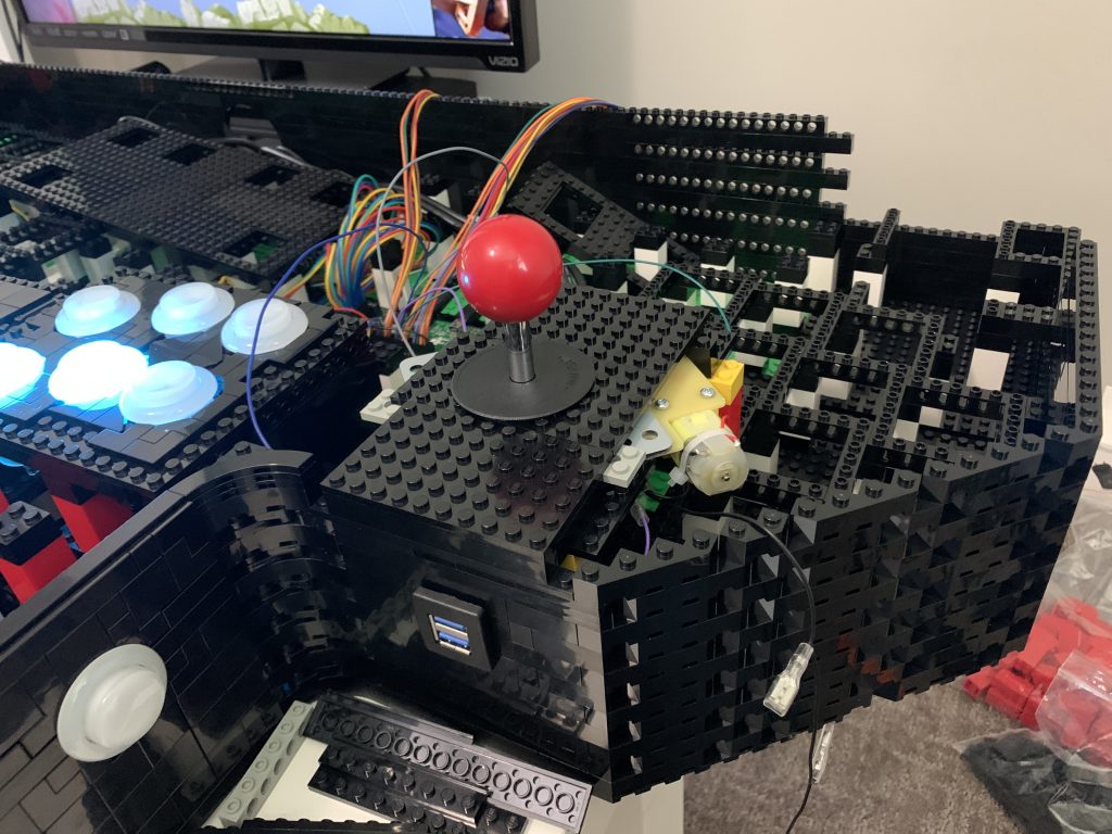 Photo of player 4 joystick getting installed and integrated into the front of the control panel above the front-right USB controls.