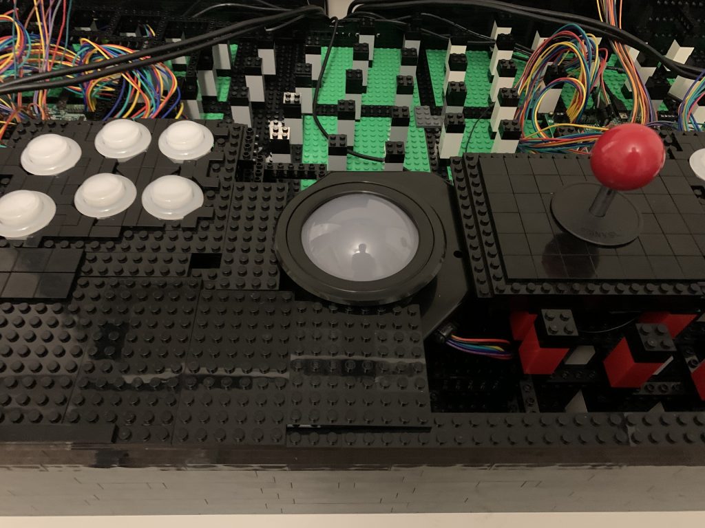 Photo of trackball getting covered in plates.