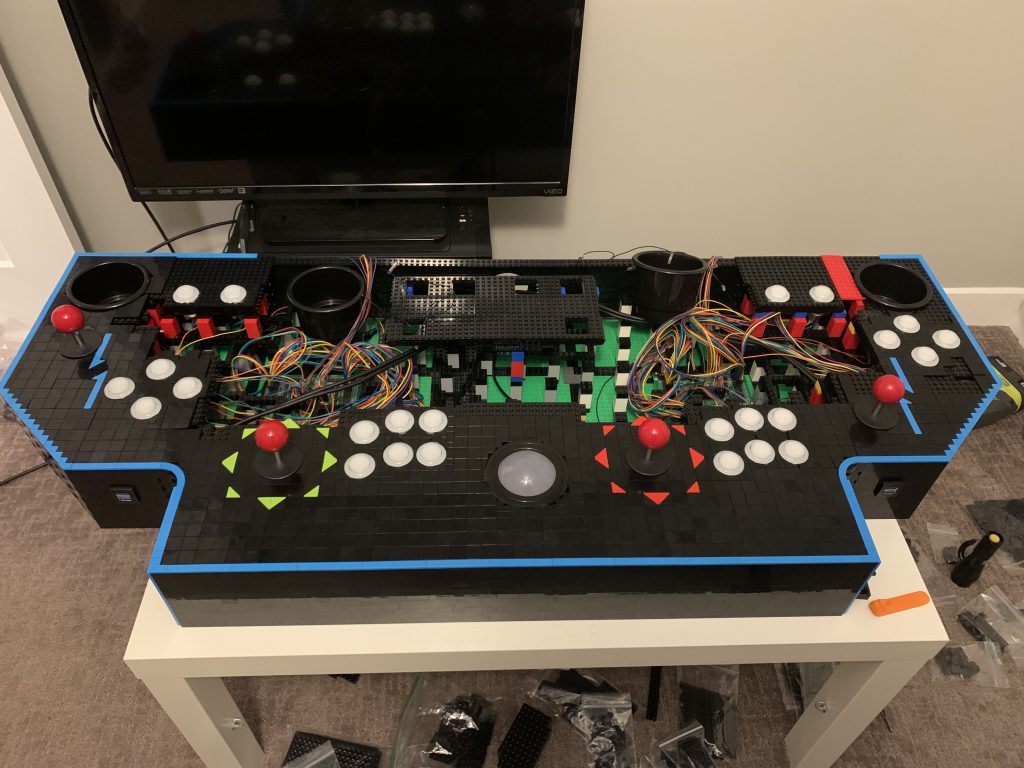 Photo showing control panel with directional arrows around players 1 and 2 joysticks and Player 2 and 4 start buttons mounted.