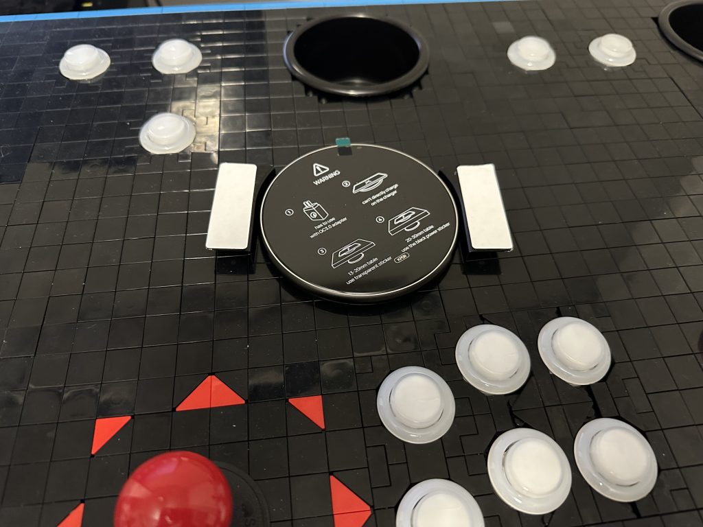 Photo showing wireless charger laying on top of empty space of control panel.