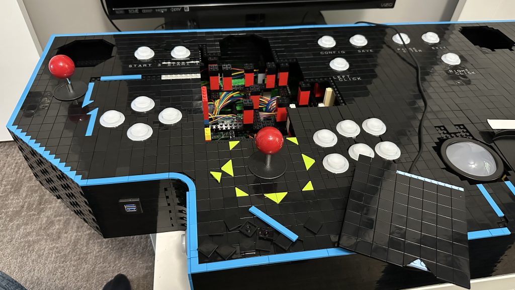 Left side of arcade panel with plate pulled off showing where charger will be installed - also letters are now installed under the common buttons