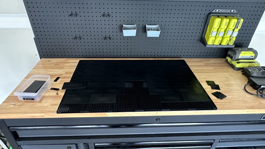 Photo showing the base on a workbench with some of the tiles added on top