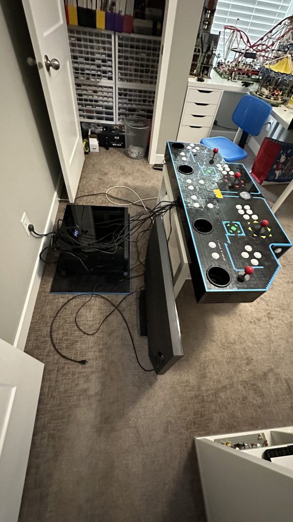 Photo of the new base sitting on the floor with the computer on top of it. Lots of wires dangling above to the control panel