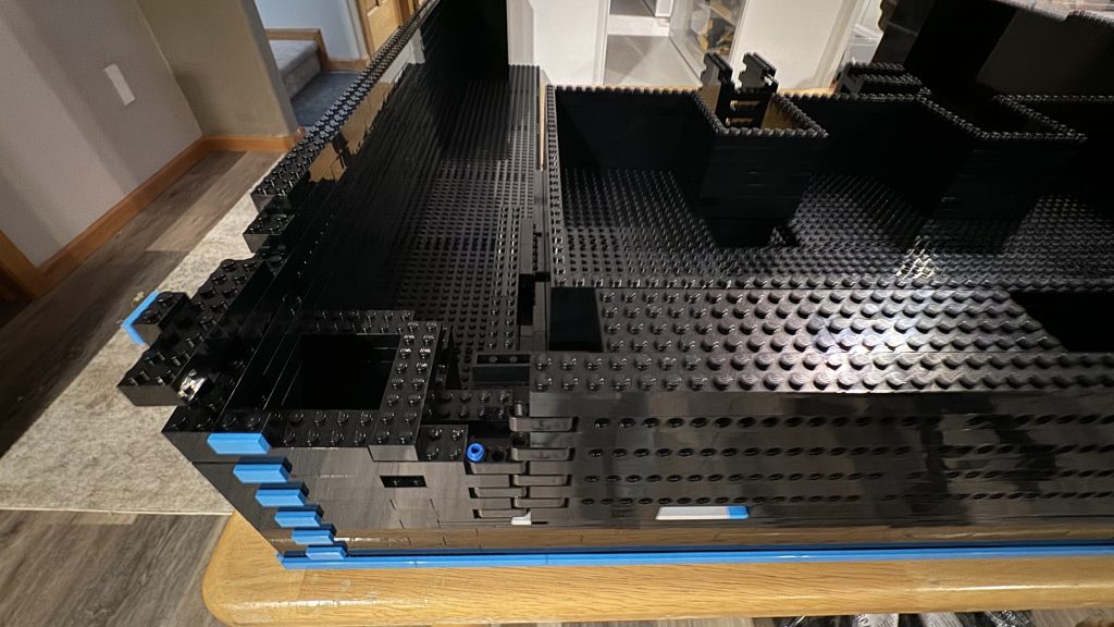 Photo showing the box attached to the back of the door with the upside down "rod" brick resting past the wall where the door opens