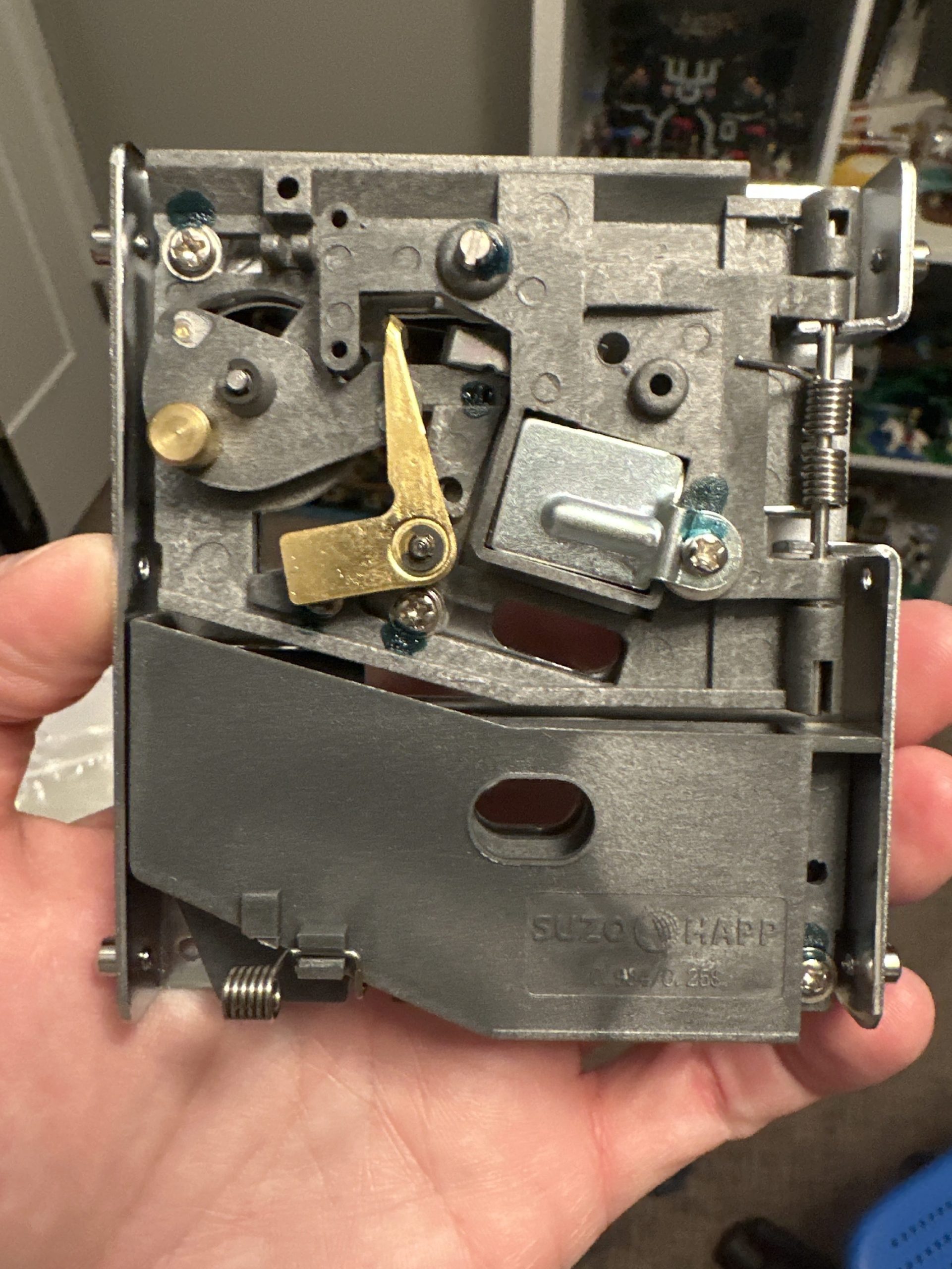 Photo of mechanical coin chute for arcade machine to insert coin into for credit