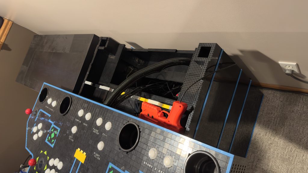 Photo showing the back of the control panel with mass of cables coming out the back and needing to be fished down through the cabinet to the computer at the bottom