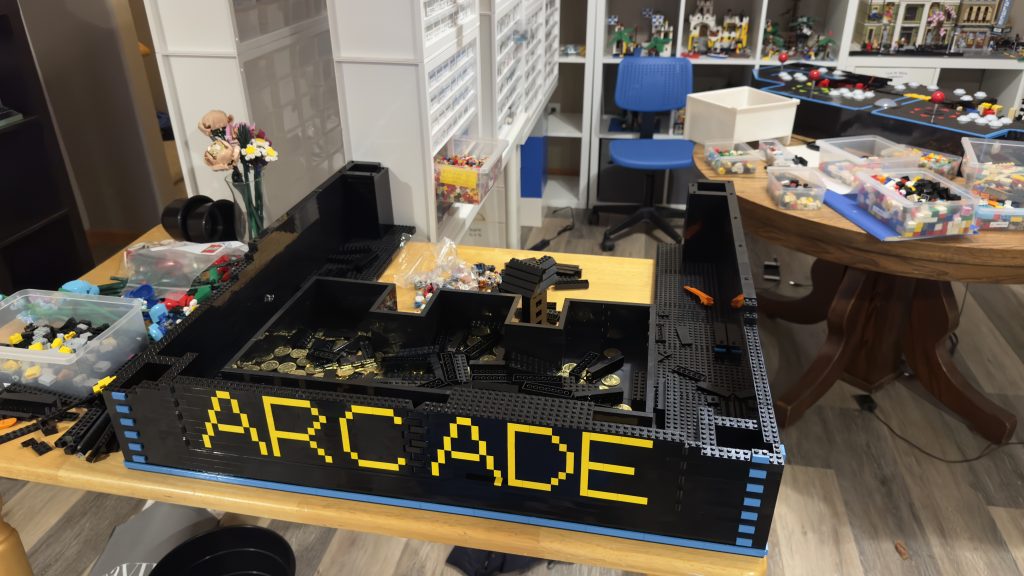 Level up! Photo showing the new door installed into the coin bin section of the cabinet. Yellow letters in the side of the door spell, "ARCADE".