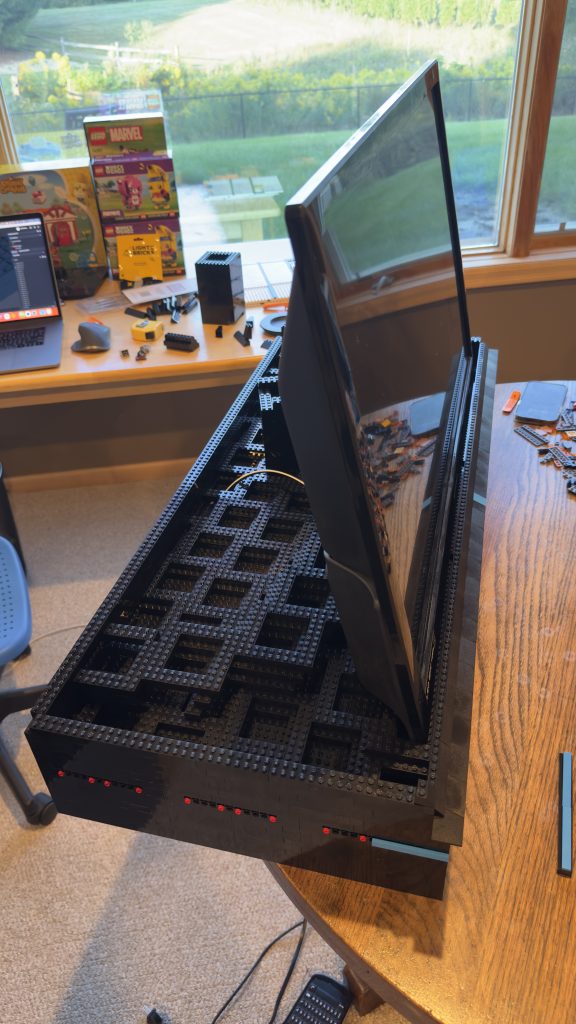 Photo showing the screen leaning against and being held up by brick behind it