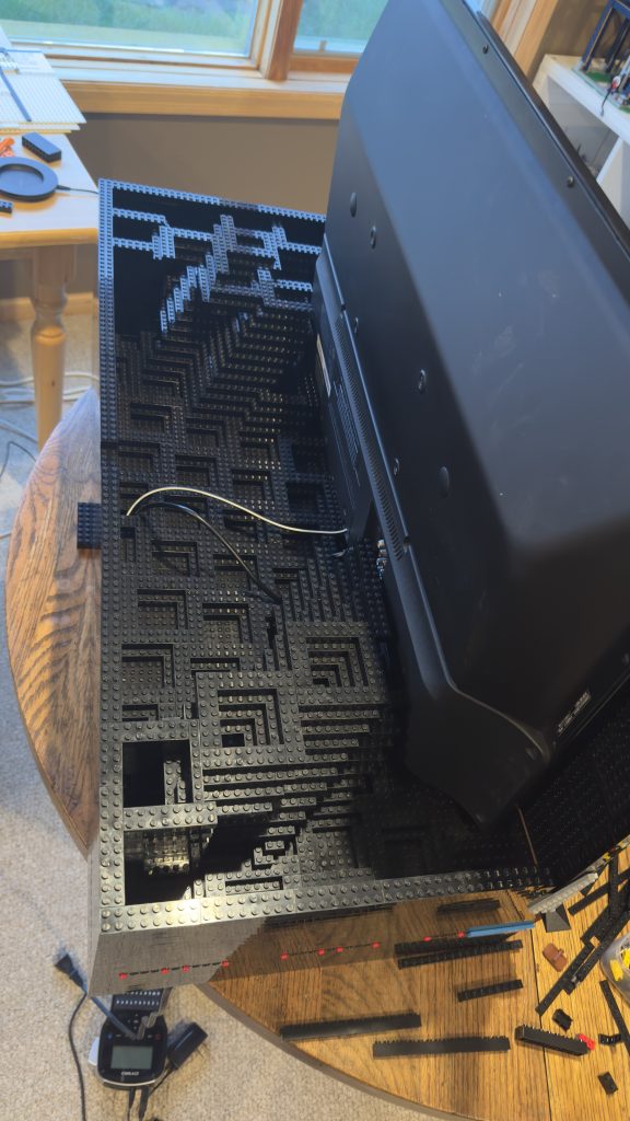 Photo showing the big video display resting nicely inside while I build up the surrounding walls