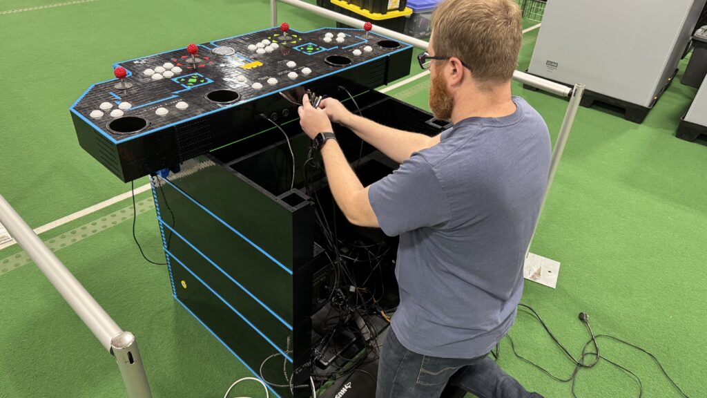Setting up - the control panel is attached and now plugging in the wires from the computer and the coin chutes to the control panel