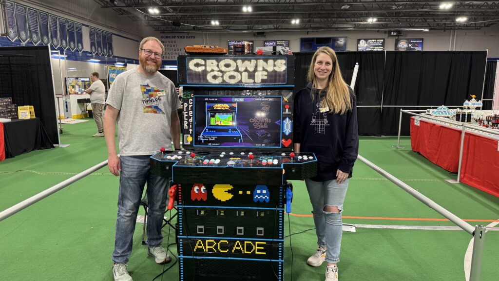 Photo of my wife and I standing next to the arcade