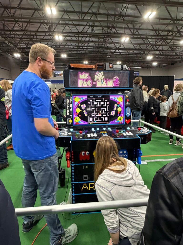 Photo of my wife and i demonstrating features of the arcade.